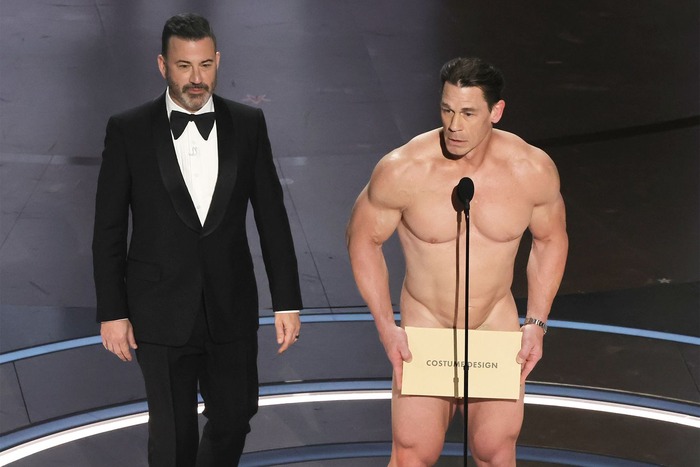 John Cena presenting on stage with the award