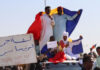 Protesters wave Chadian flags during an anti-France demonstration in N'djamena on 6 December 2024.